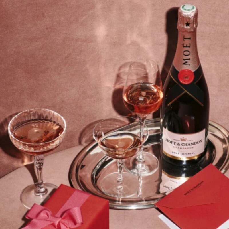 Moët & Chandon rosé champagne with glasses and gift in romantic setting