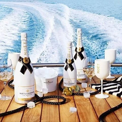 Moët & Chandon Ice Impérial champagne bottles served on a yacht with ice buckets and champagne glasses