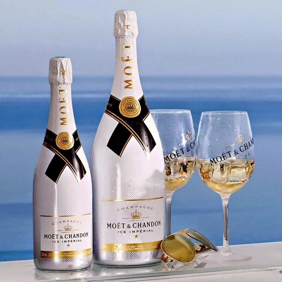 Moët & Chandon Ice Impérial Magnum with champagne glasses by the sea