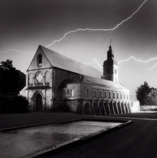 Black and white image of Hautvillers Abbey with lightning above the Dom Pérignon heritage site
