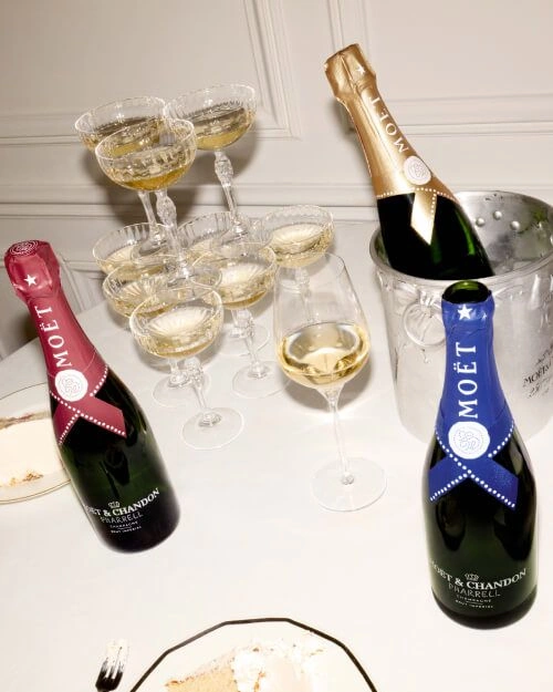 Moët & Chandon Pharrell Limited Edition champagne bottles on party table with filled glasses