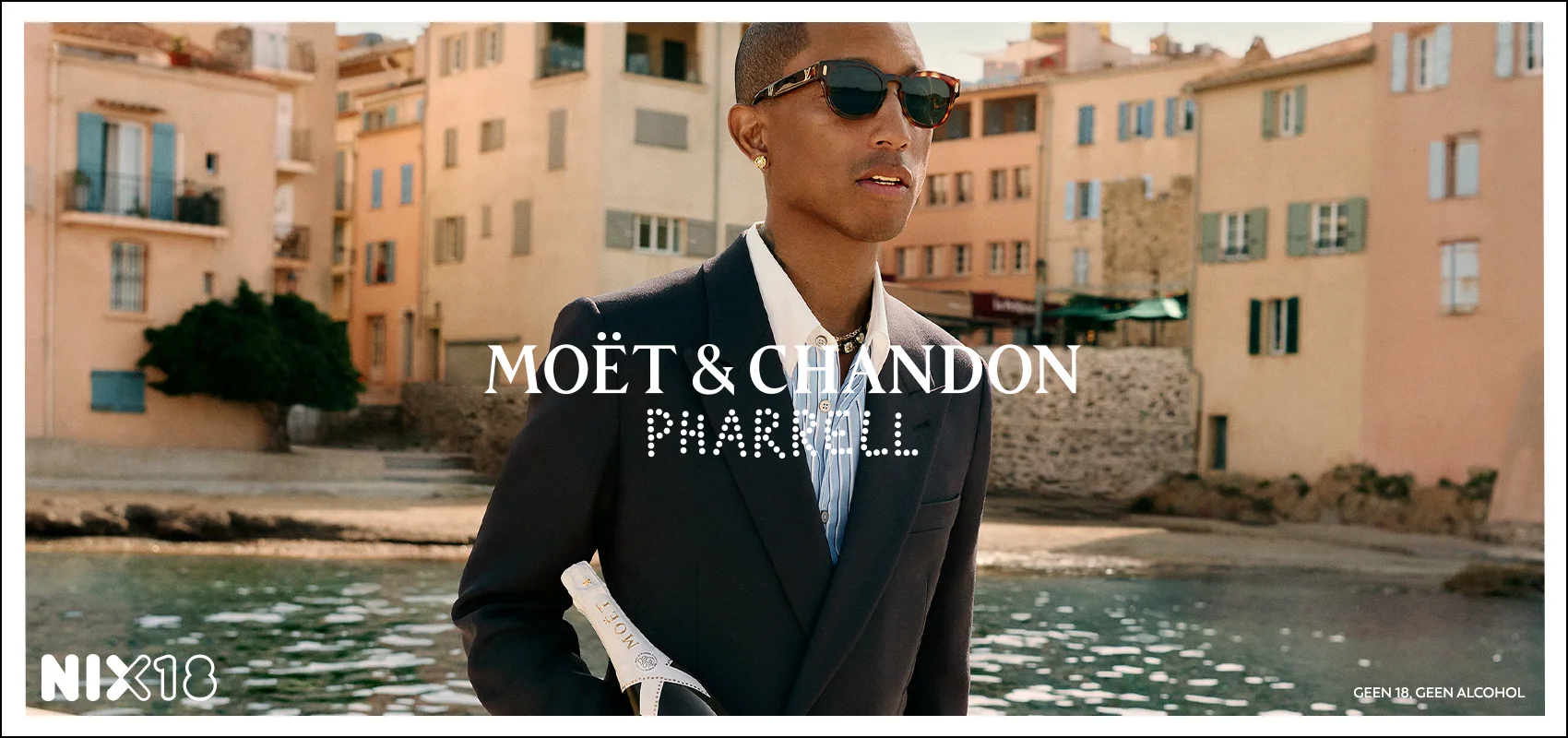 Pharrell Williams with Moët & Chandon Ice Impérial bottle by the water