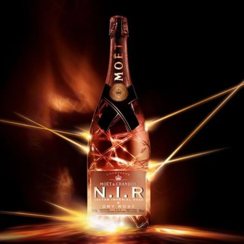 Moët & Chandon N.I.R. Nectar Impérial Rosé Dry champagne bottle with illuminated rosé design against a dark background