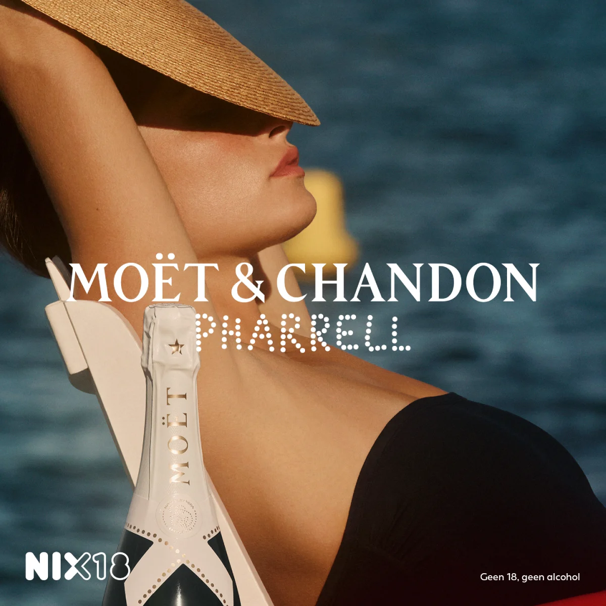 Moët & Chandon Ice Impérial Pharrell Williams Limited Edition bottle in front of model wearing sun hat